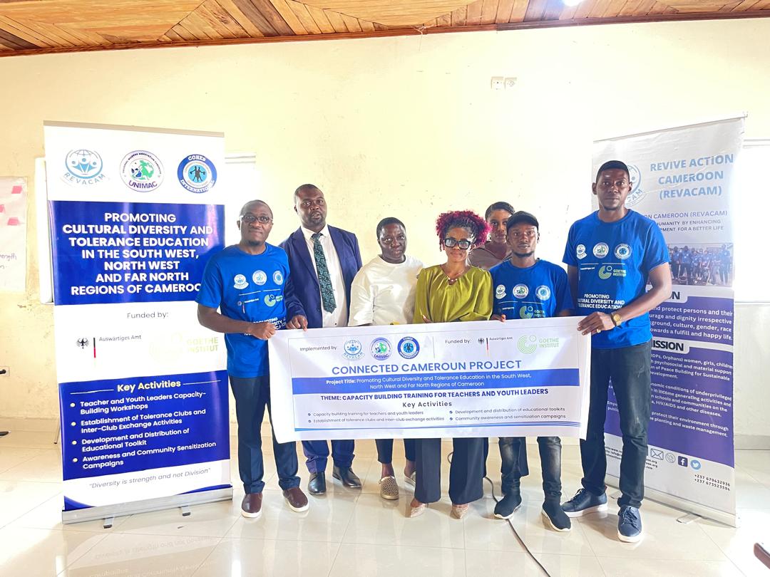 Young Teachers with banner