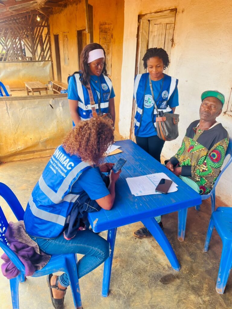 UNIMAC team members recording the views of an elderly community member in Njong Village